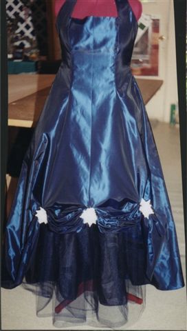 Taffeta halter dress.,flowers swoop up skirt to reveal crinoline
